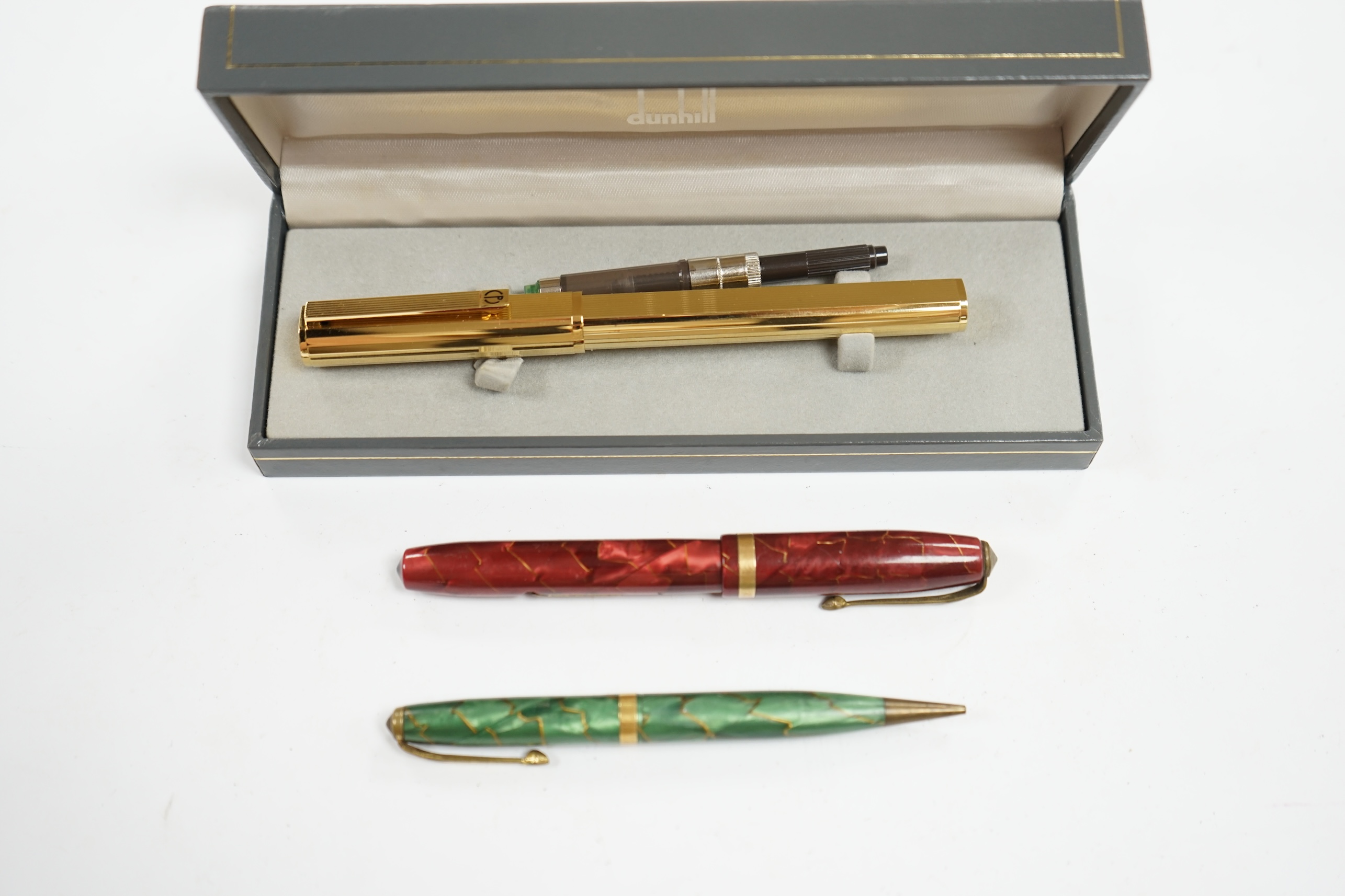 A cased Dunhill gold plated fountain pen and two other pens, Dunhill pen 13.5cm long. Condition - fair